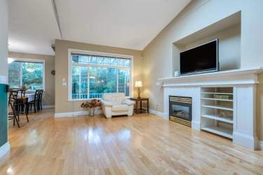 Bright Family Room with valued ceiling and gas fireplace.