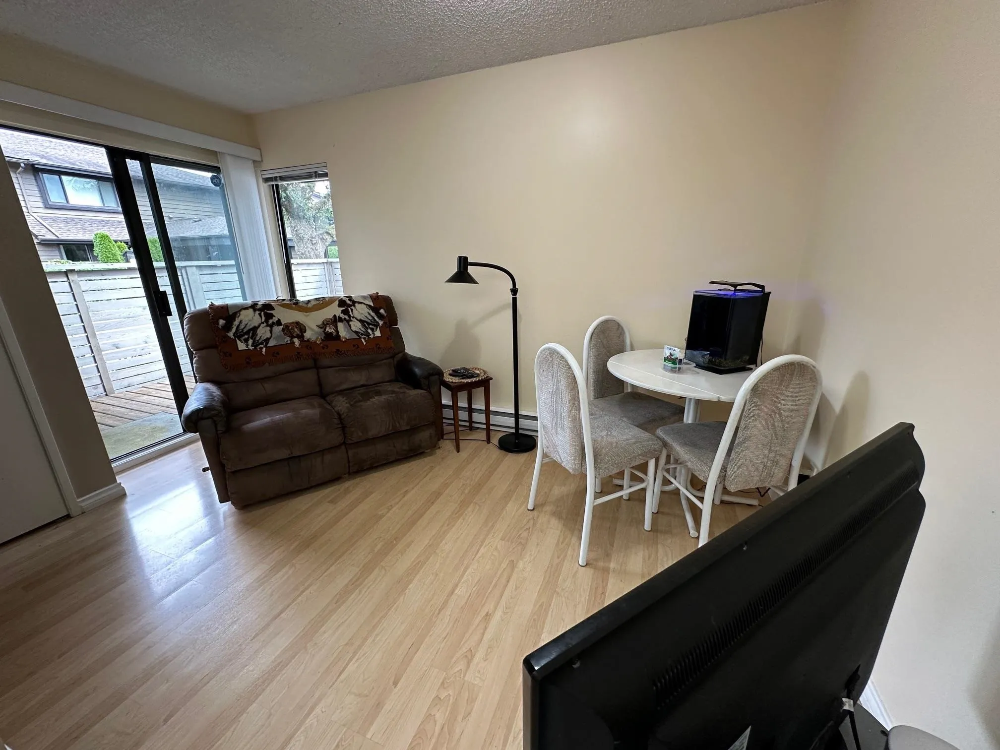 In the family room off the kitchen -- it's perfect for an eating area too. A sliding glass door opens onto the front deck which has a gate for easy access to your carport.