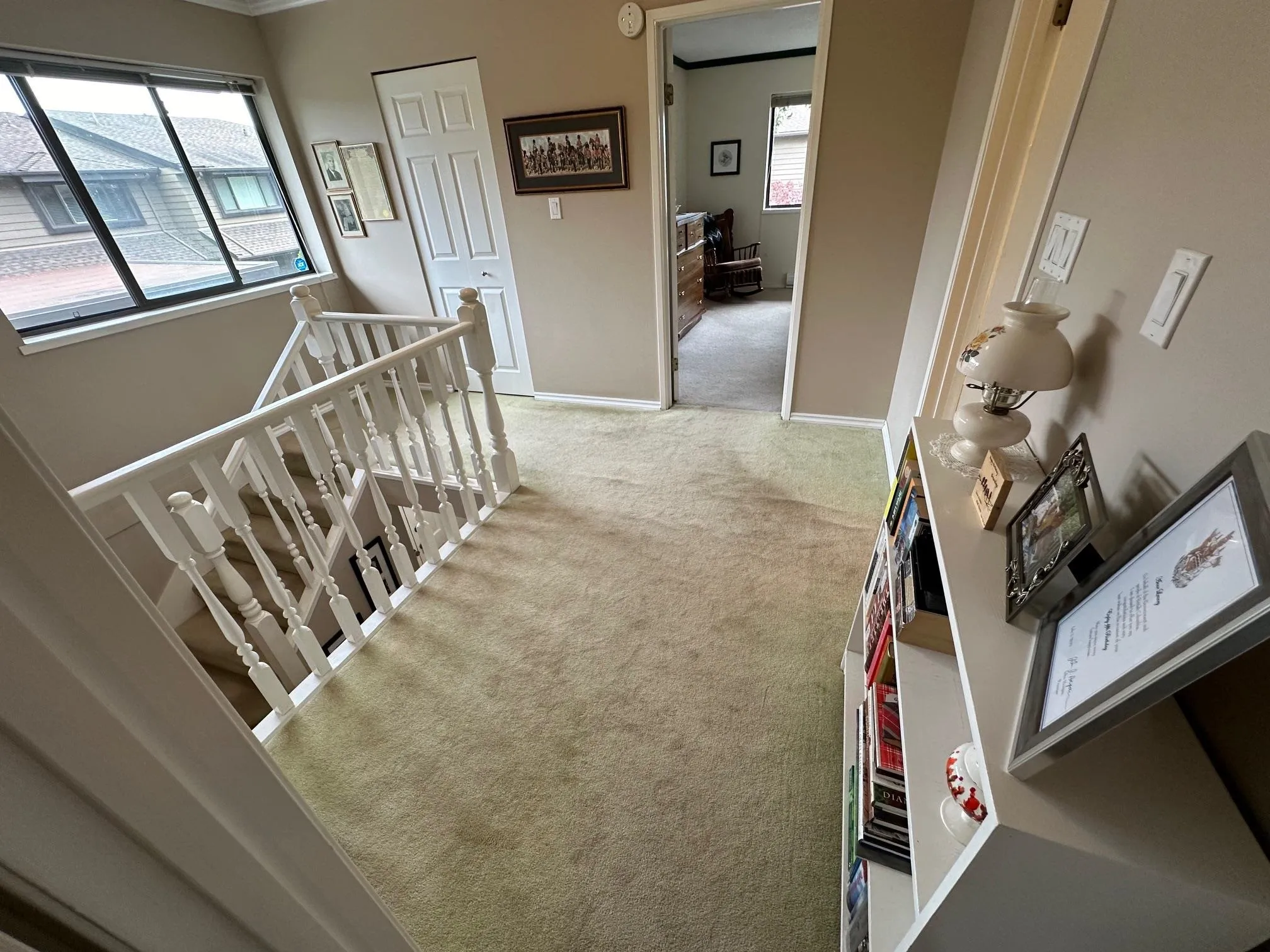 The upper hallway is spacious and bright. The window faces east.