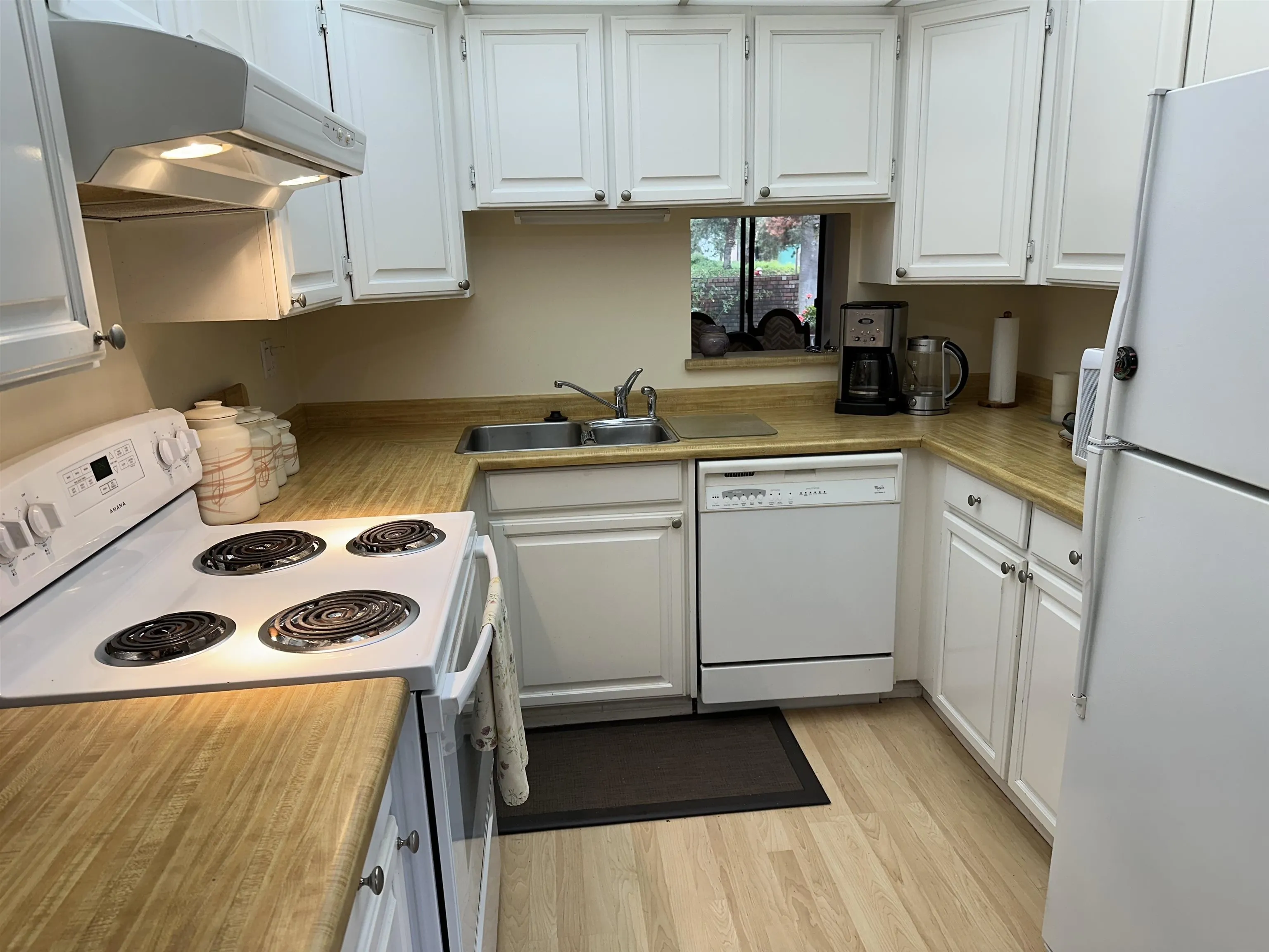 The compact kitchen means more space for a kitchen eating area or a family room. There is a pass thru window into the dining area.