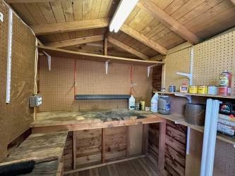 Laminate flooring runs from the entrance into the family room. There's a large coat closet (pictured) plus a second closet where the hot water tank hides. This second closet uses the space under the stairs!