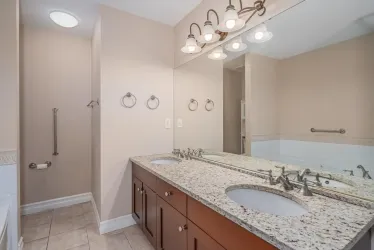 With double vanity and granite countertops.