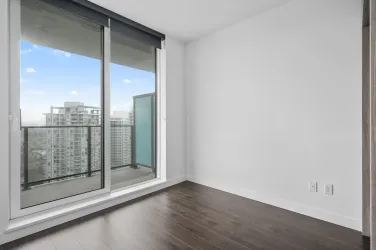 Bedroom with balcony access.