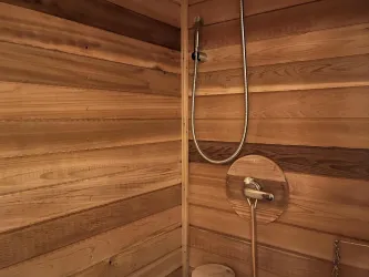 Sauna enclosure has been added to the existing shower stall for your private enjoyment